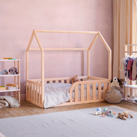 Bright nursery featuring Roomix toddler house floor bed with soft bedding and warm, inviting decor for family comfort