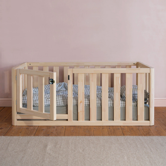 Cozy toddler floor bed with house-shaped frame and supportive mattress, designed for comfort and secure sleep