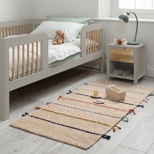 Roomix transition toddler bed in natural pine with safety rails, shown in a child's bedroom