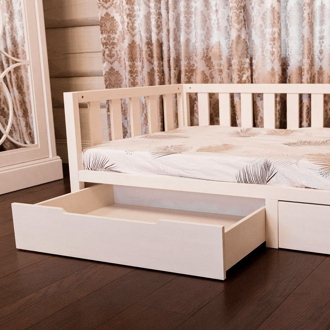 Raised toddler bed with built-in drawers underneath, offering smart storage and space-saving design