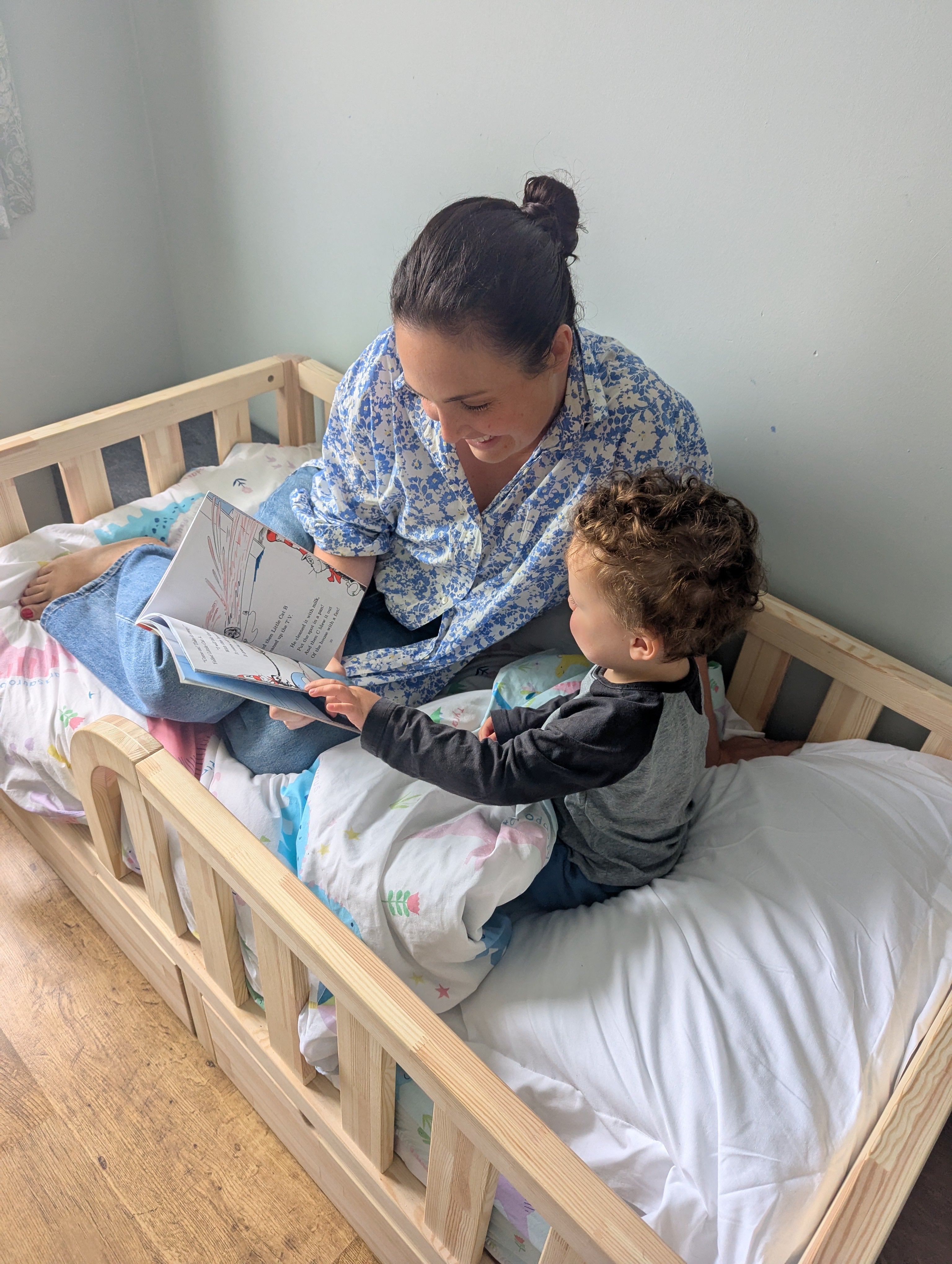 Cozy toddler floor bed with soft mattress and wooden frame, perfect for safe and comfortable sleep in a modern nursery.
